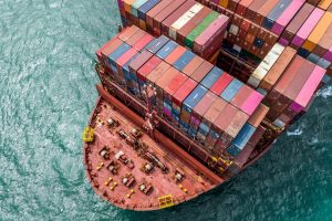 Aerial view of a container ship’s stern showing mechanical deck and shaft area at sea